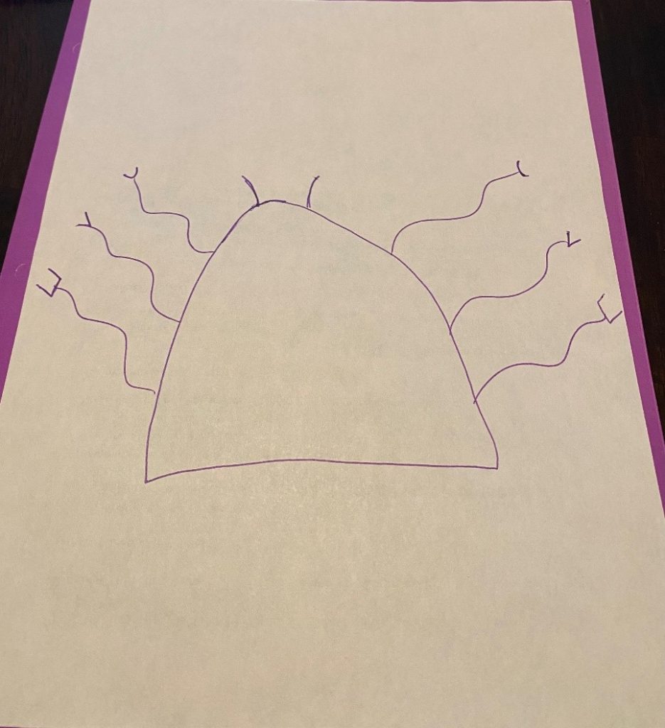 Monster shape with arms on paper